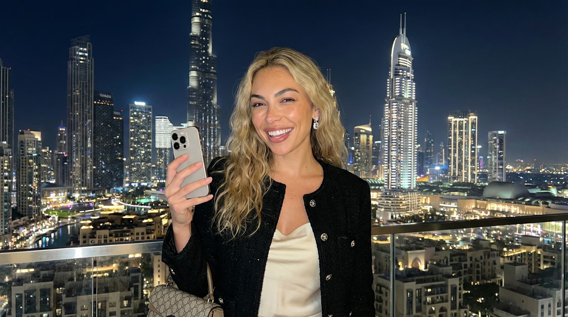 Burj Khalifa and Dubai skyline at night with illuminated skyscrapers, long-exposure city lights, vibrant glass facades reflecting colors, and panoramic view from Business Bay or Dubai Creek showcasing the world's tallest building at 828 meters